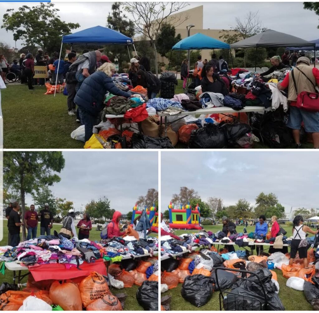 A group of people standing around some bags